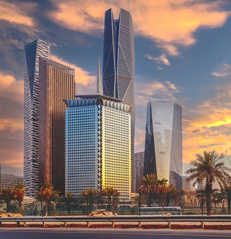 The skyline of King Abdullah Financial District (KAFD) glows at sunset, highlighting its striking architectural towers and palm-lined surroundings—symbolizing Riyadh’s thriving business future.